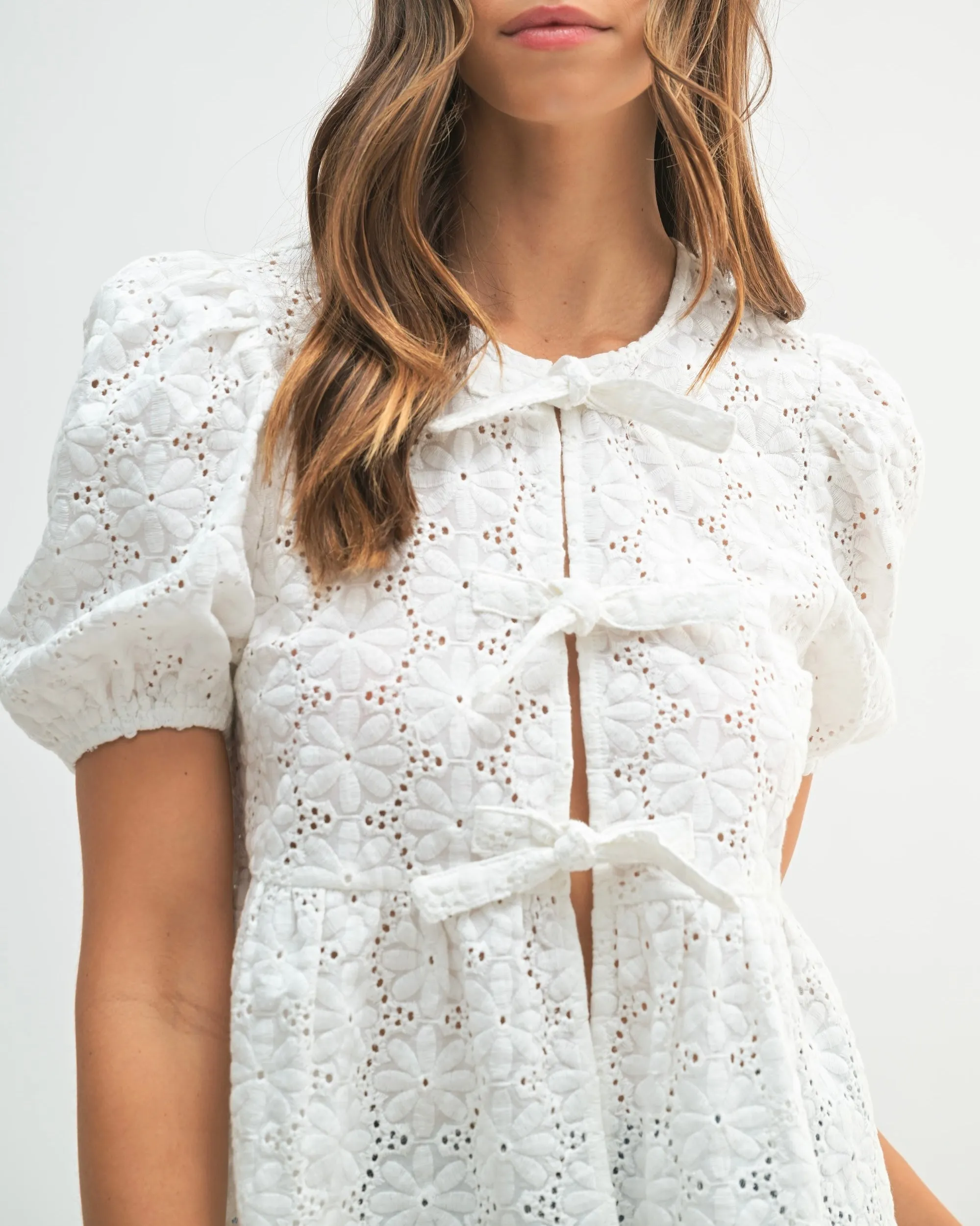 Eyelet Puff Sleeve Bottom Ruffle Front Tie Top in Off White